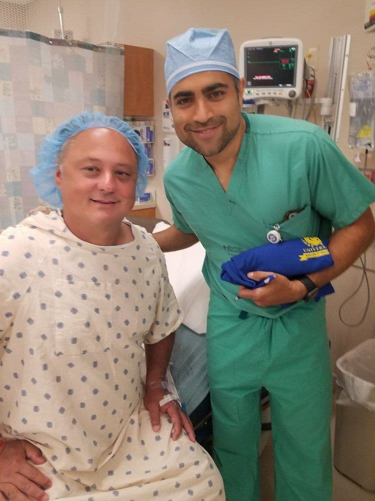 Dr. Kella with a patient in a clinical setting