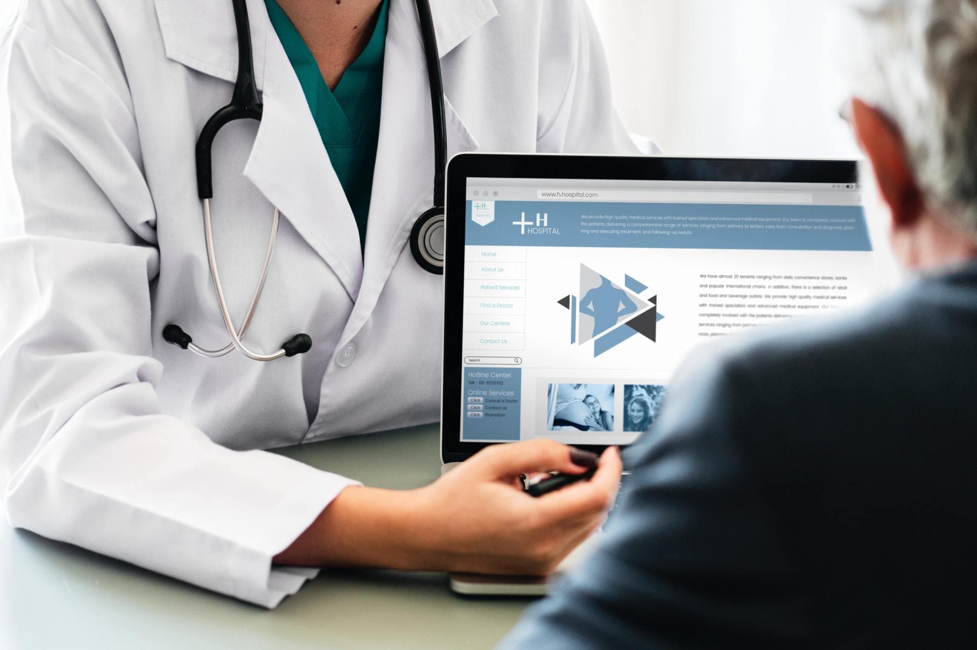 Doctor reviewing health information on a laptop with a patient